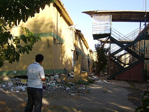 Diego Grez in front of destroyed apartments in Paniahue, Santa Cruz, Chile