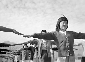 Female internees practicing calisthenics at Manzanar Relocation Center, Owens Valley, California