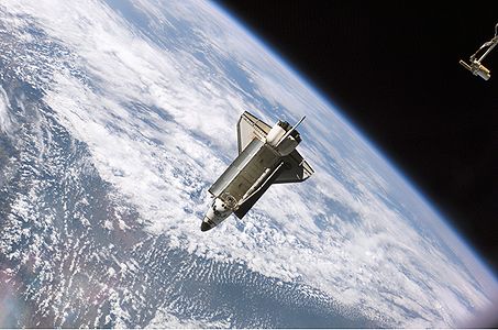 The Space Shuttle Atlantis, backdropped against clouds over Earth, is pictured after it undocked from the International Space Station at 7:50 a.m. CDT, Sept. 17, 2006. The STS-115 astronauts completed six days, two hours and two minutes of joint operations with the station crew.