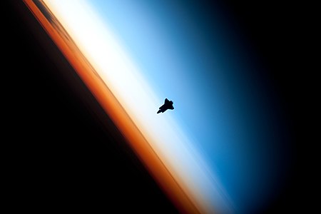 Space Shuttle Endeavour seen against layers of the Earth's atmosphere