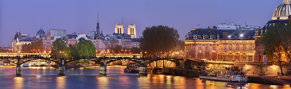 Panorama of Paris, featuring the pont des arts (bridge of arts) and just behind, the pont Neuf (new bridge) and the île de la Cité. The institut de France (french institute) stands on the right, at the end of the pont des arts. The towers of Notre-Dame de Paris cathedral can also be seen on the far behind.