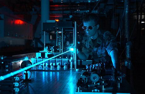 Military scientist operates laser in test environment