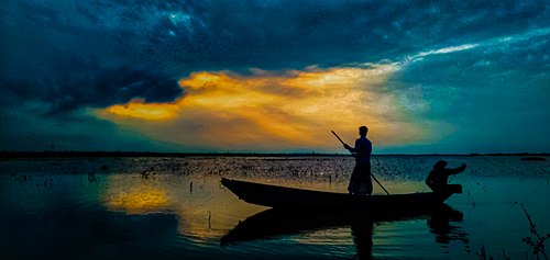 A boatman is riding on a boat in Titash river