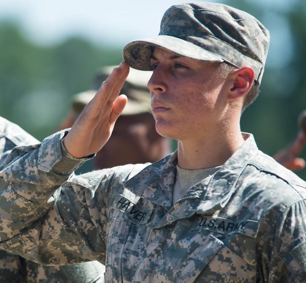 Soldier saluting, with hair in a buzz cut according to old grooming standards